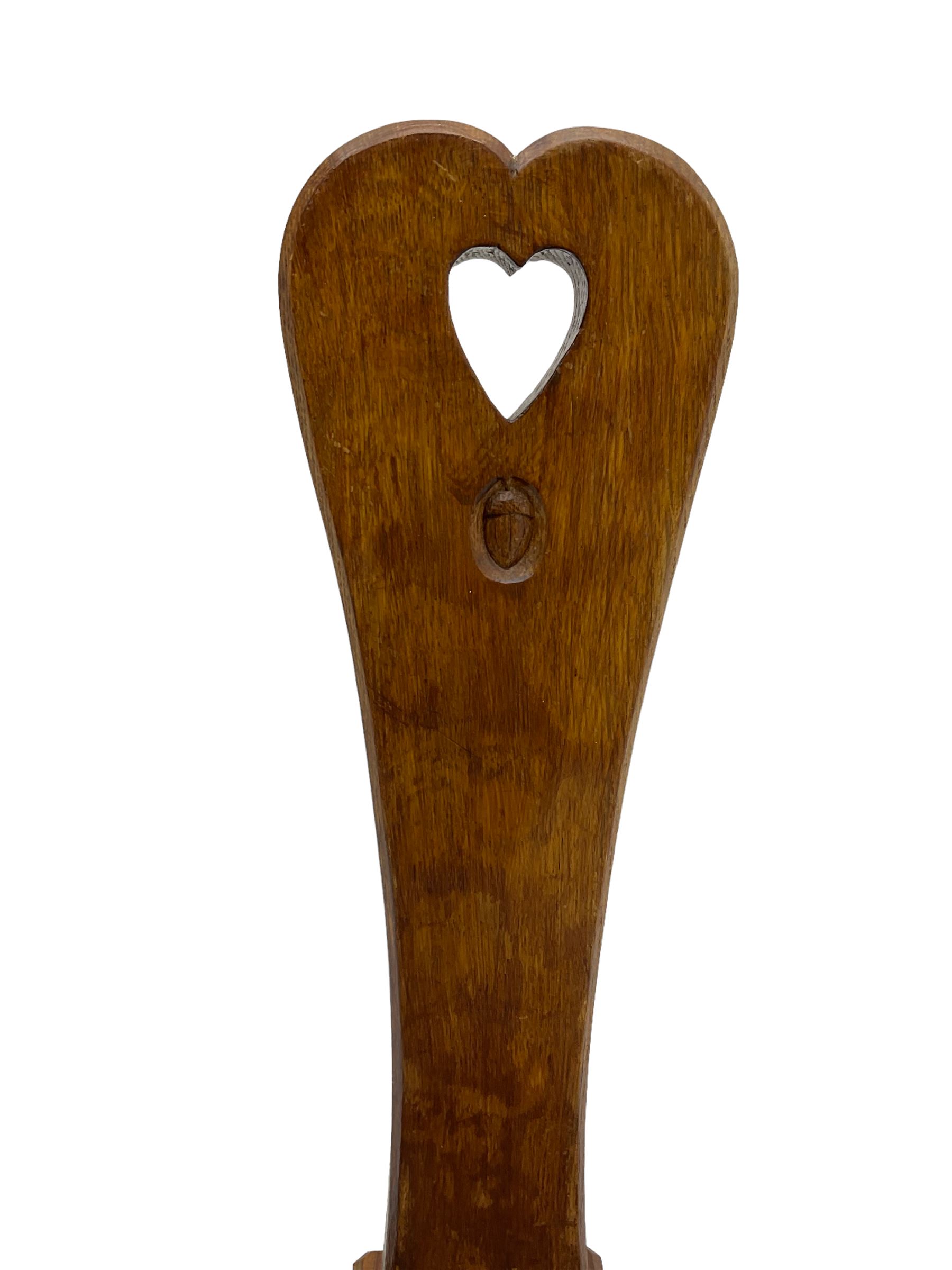 Acornman - adzed oak spinning chair, spoon shaped back with pierced heart and acorn signature, spade-shaped seat raised on octagonal tapering supports by Alan Grainger of Brandsby