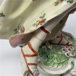 18th century Derby figure of Diana the huntress, circa 1760, modelled reaching for an arrow from quiver across her back, with recumbent hound at her feet, upon a scrolled base with bocage detail, H27.5cm