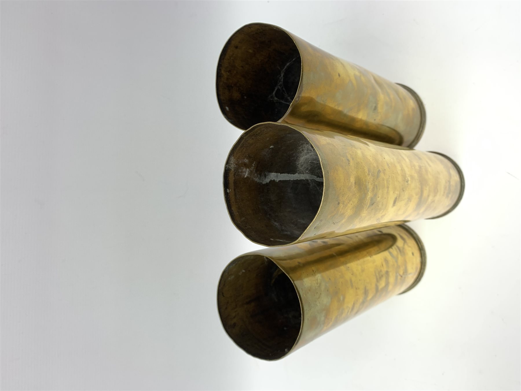 Three early 20th century plain brass shell cases, dated 1911, 1915 and 1916, tallest H35cm (3)