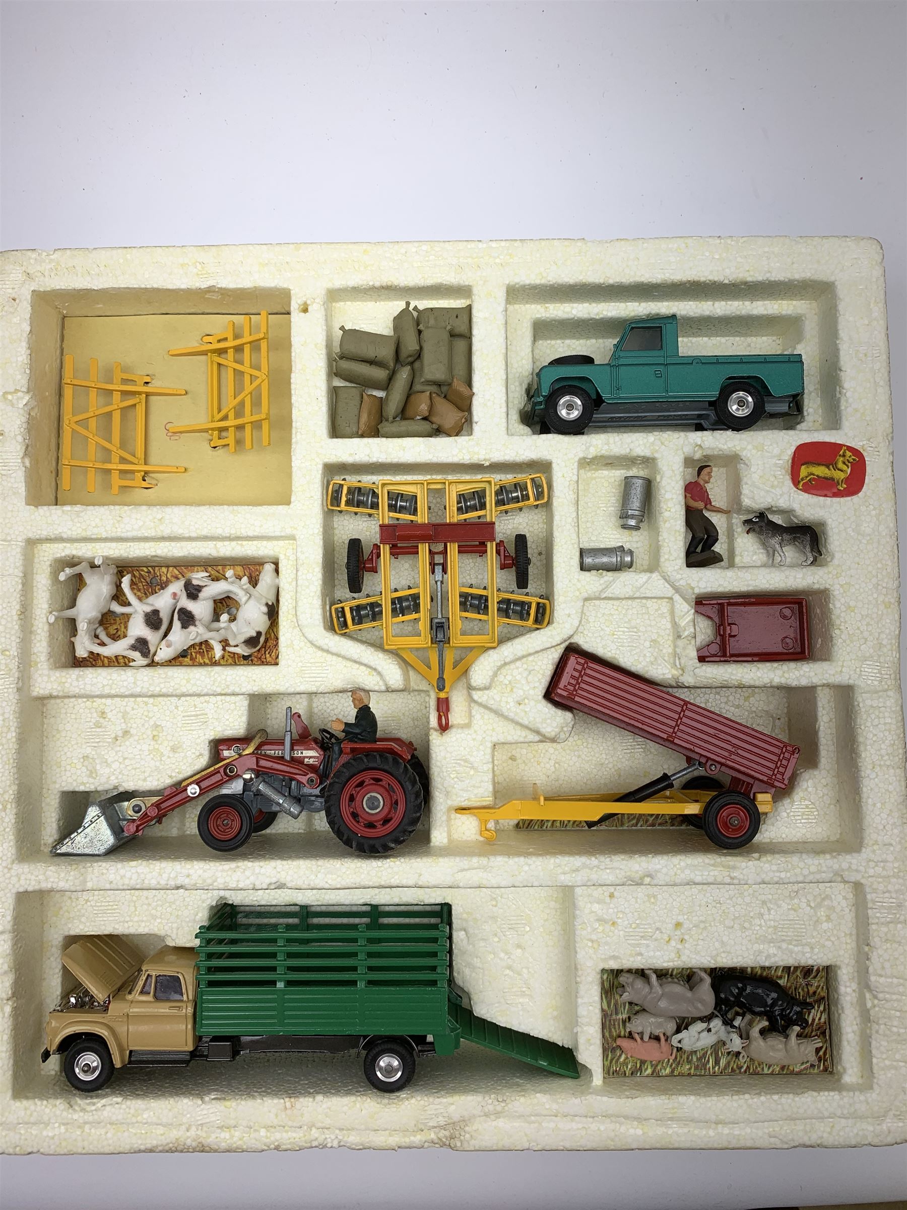 Corgi Toys Agricultural Gift Set No.5 containing Massey-Ferguson 165 Tractor with shovel and skip and churns attachment with two churns, Tandem disc harrow, farm tipper trailer with raves, Land Rover, Dodge Kew Fargo truck with four cattle and four pigs, farm worker and dog,  eleven large sacks and five small sacks, boxed