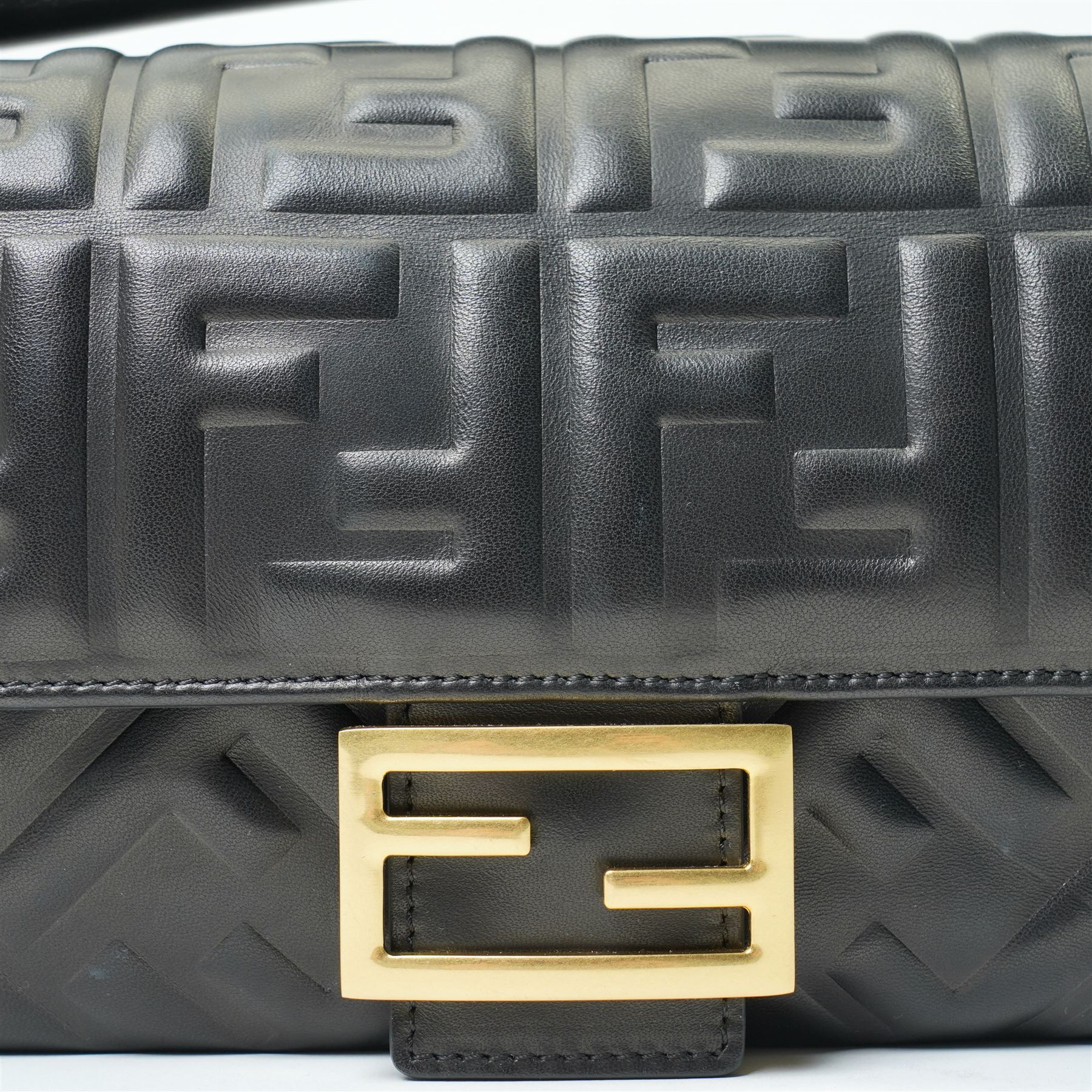 Fendi Baguette shoulder bag, black nappa leather with embossed FF monogram and quilted panels, the front flap secured by a gold-tone FF logo magnetic clasp engraved Fendi Made in Italy, with detachable leather shoulder strap and gold-tone hardware, interior leather tab stamped 'Baguette Fendi Made in Italy', together with original Fendi dust bag and box, W27cm D7cm H15cm