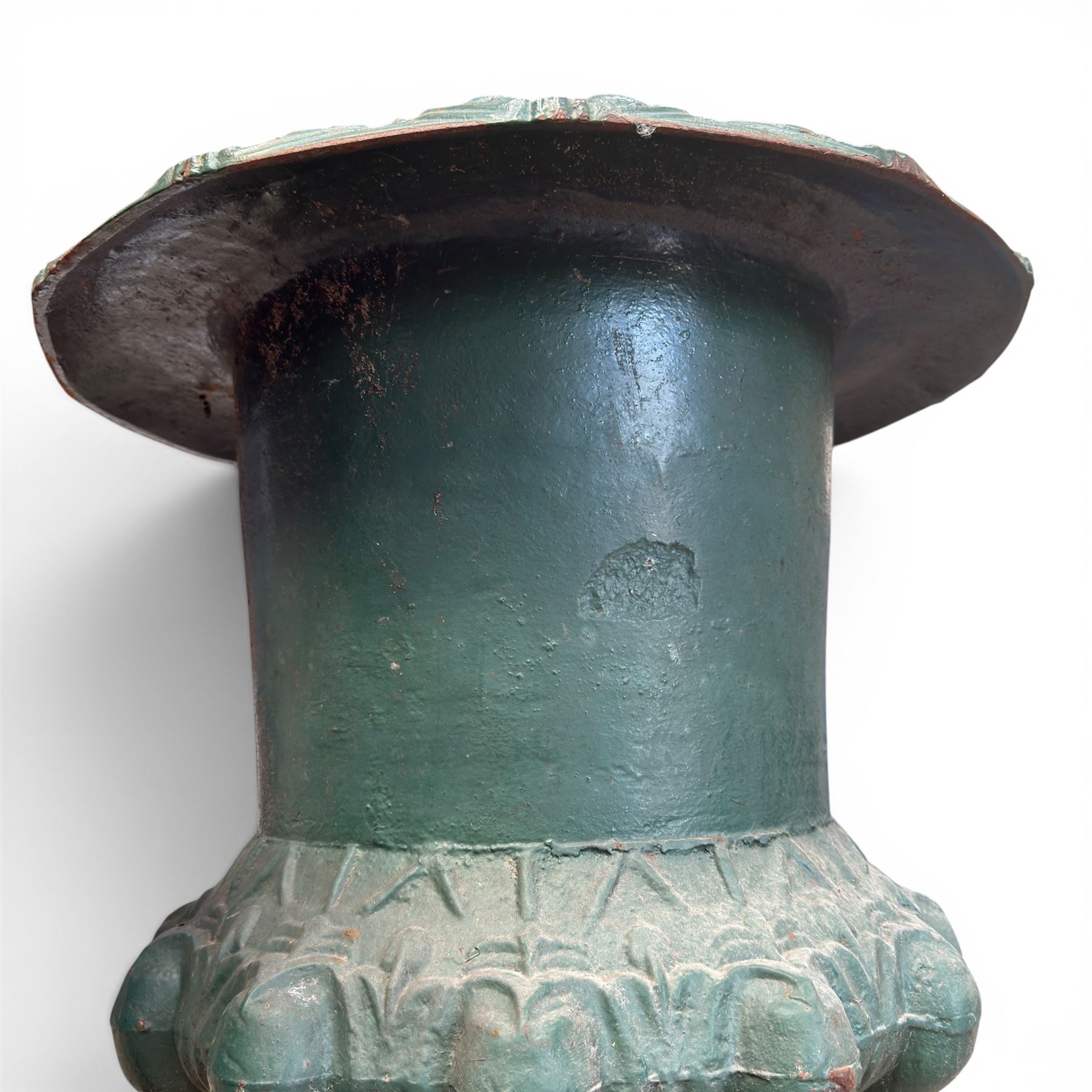 Pair of Victorian cast iron campana garden urns, the flared rim with repeating stylised anthemion motifs with scrollwork, over a deep gadrooned and Aesthetic moulded underbelly, fluted and foliate lower bowls on square pedestal bases, in antique green-painted finish
