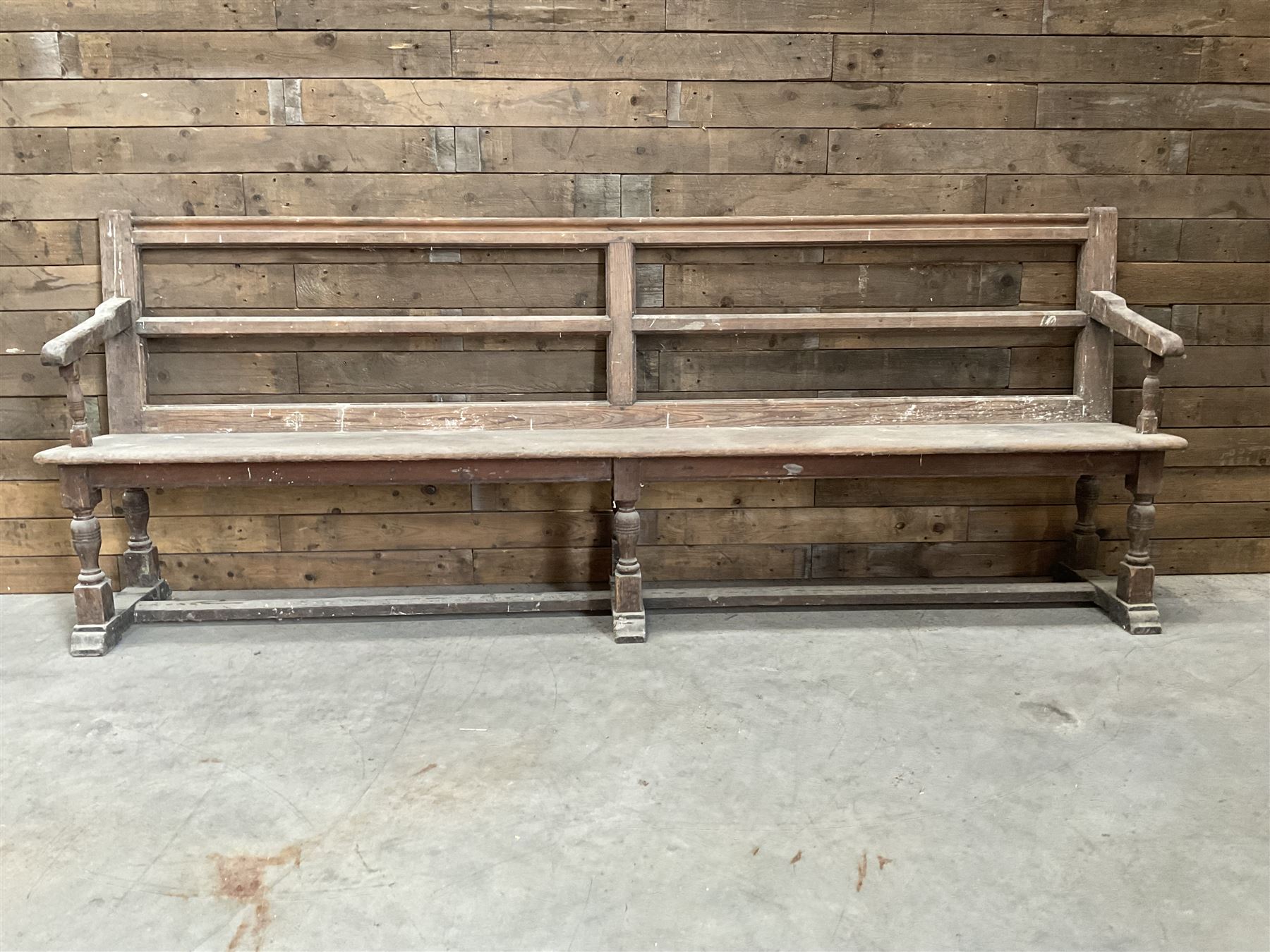 Victorian pitch pine bench pew, turned arms and legs, rail back with plank seat, 249cm