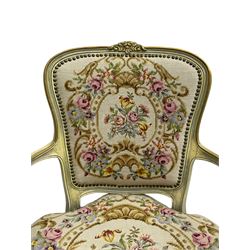 Near pair of French Louis XVI design lacquered hardwood-framed parlour elbow chairs, moulded flower head cresting rail over scrolled arm terminals, back and seat upholstered in prink and cream floral and urn decorated tapestry fabric, on cabriole supports, in craquelure cream finish with painted gilt piping
