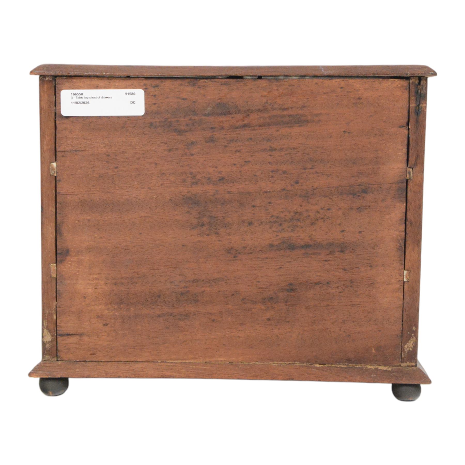 Table top chest of drawers, of rectangular form, with two short and two long drawers, raised upon bun feet, H22cm