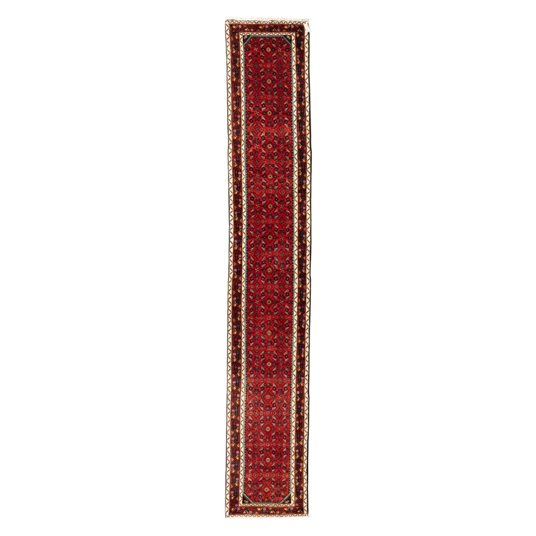 North West Persian Malayer runner, madder red field decorated with an all-over design of stylized herati motifs in shades of indigo, ivory, and green within ivory and dark blue borders of angular vine and rosette design, with cotton fringe ends 