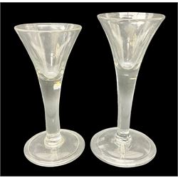 Two 18th century drinking glasses, the drawn trumpet bowl upon plain tapering stem and folding foot, tallest H16.5cm