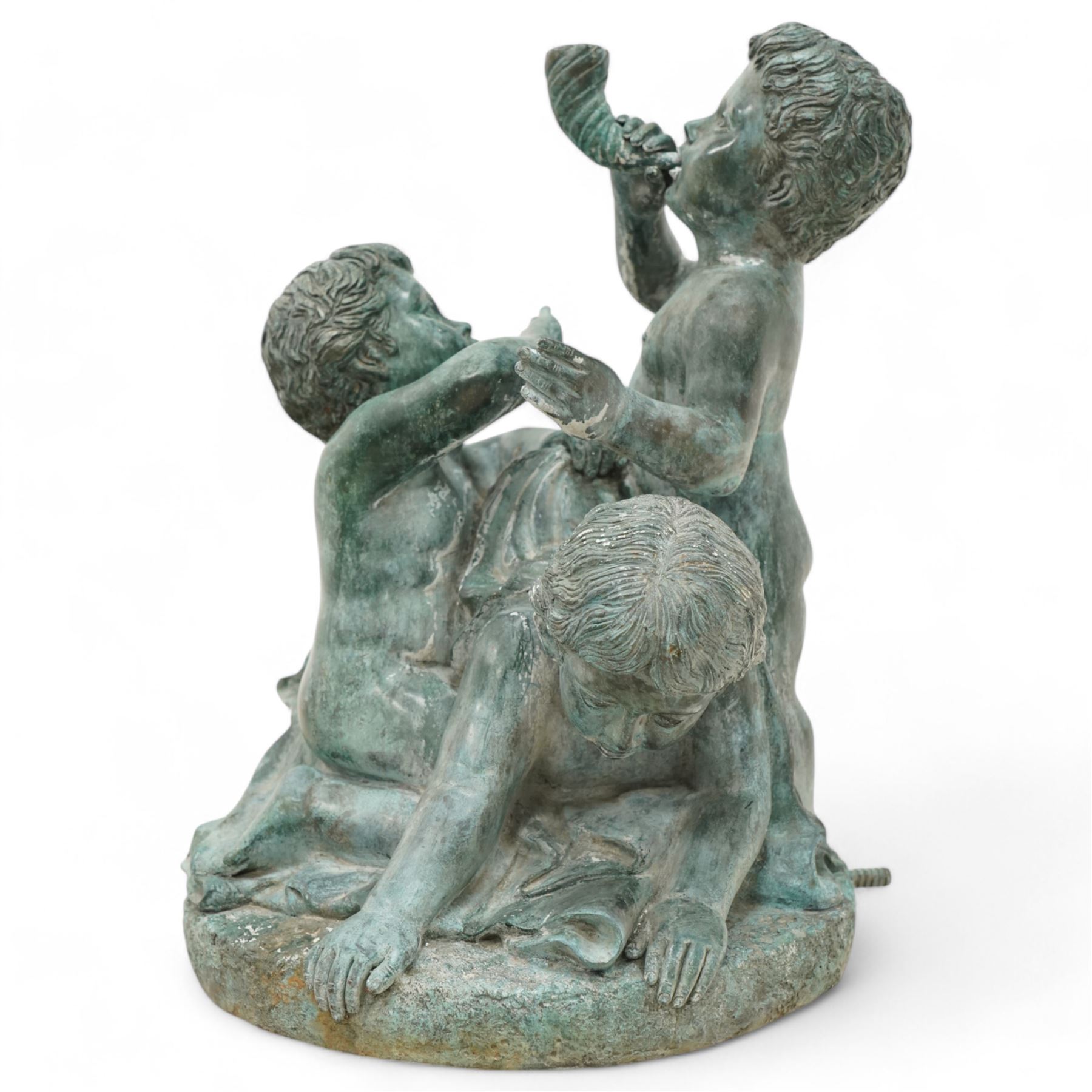 Cast bronze garden water fountain in the form of three Putti on circular naturalistic base, stamped 'Leonardo Rossi'  