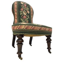 Victorian walnut nursing chair, turned front supports with brass and ceramic  castors, upholstered in floral patterned fabric