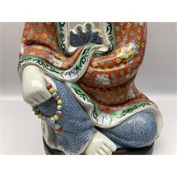 Tall Chinese polychrome figure of Guanyin (Guan Yin), the Goddess of Mercy and compassion, the Bodhisattva modelled seated and holding a rosary donning elaborate floral robes and beads, with four character seal marks beneath, H53cm