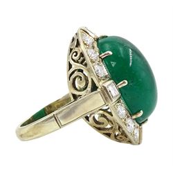 Gold emerald and diamond ring, the central oval cabochon emerald, with sixteen round and rectangular cut diamond halo surround by Judith Crowe, hallmarked 9ct, emerald 20.00 carat, total diamond weight 2.00 carat, with World Gemological Institute report