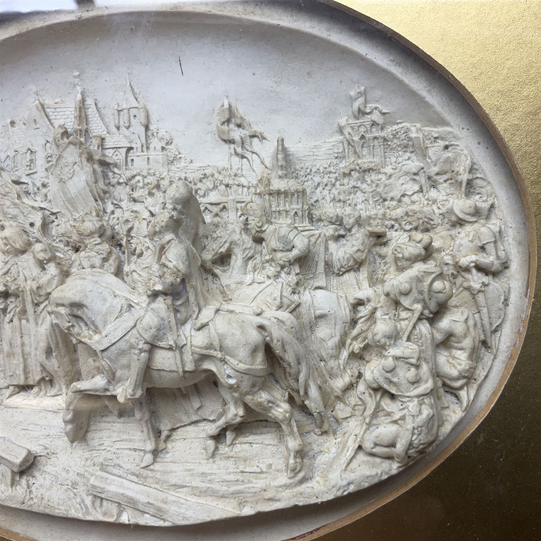 Justin Mathieu, two oval high relief plaque depicting a battle scenes, each within a wooden frame, frame  H21cm, L25cm