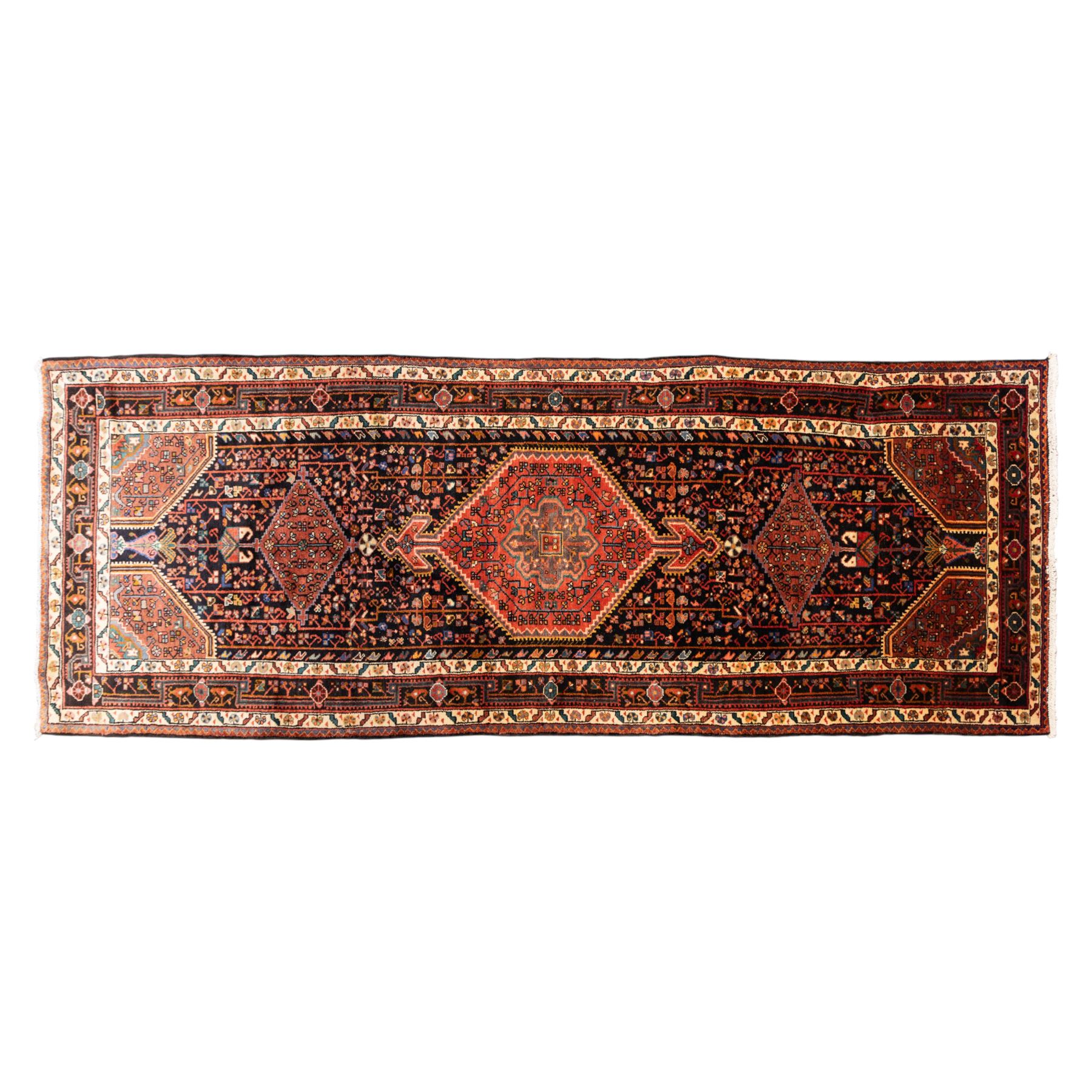 North West Persian Koliahee hand-knotted runner, indigo field with three large linked lozenge medallions in a madder red, framed by angular floral motifs and stylized vines within ivory and terracotta geometric borders, fringe ends  