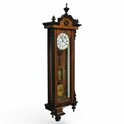 German- Late 19th century twin weight 8-day Vienna wall clock, in a walnut and ebonised case with turned finials and pendants, fully glazed door displaying the the brass cased weights and pendulum, enamel two-part dial with Roman numerals, minute rack, seconds hand and gothic steel hands, rack striking movement with a deadbeat escapement, striking the hours and half-hours on a coiled gong. With key.