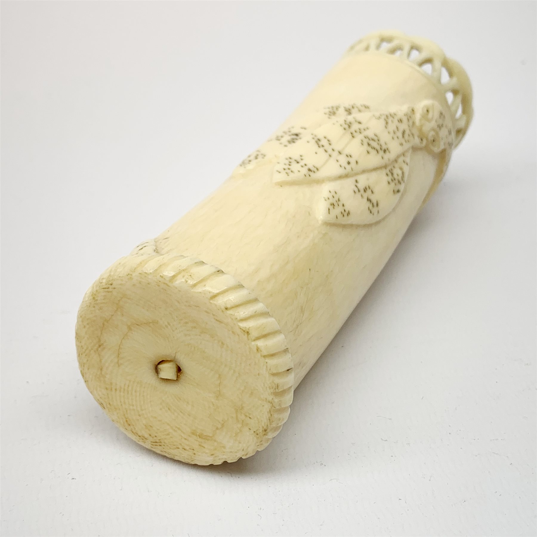 An African carved ivory spill vase, of cylindrical form with pierced rim and gadrooned band to base, the body decorated with snake and insect, signed to interior, H14cm.