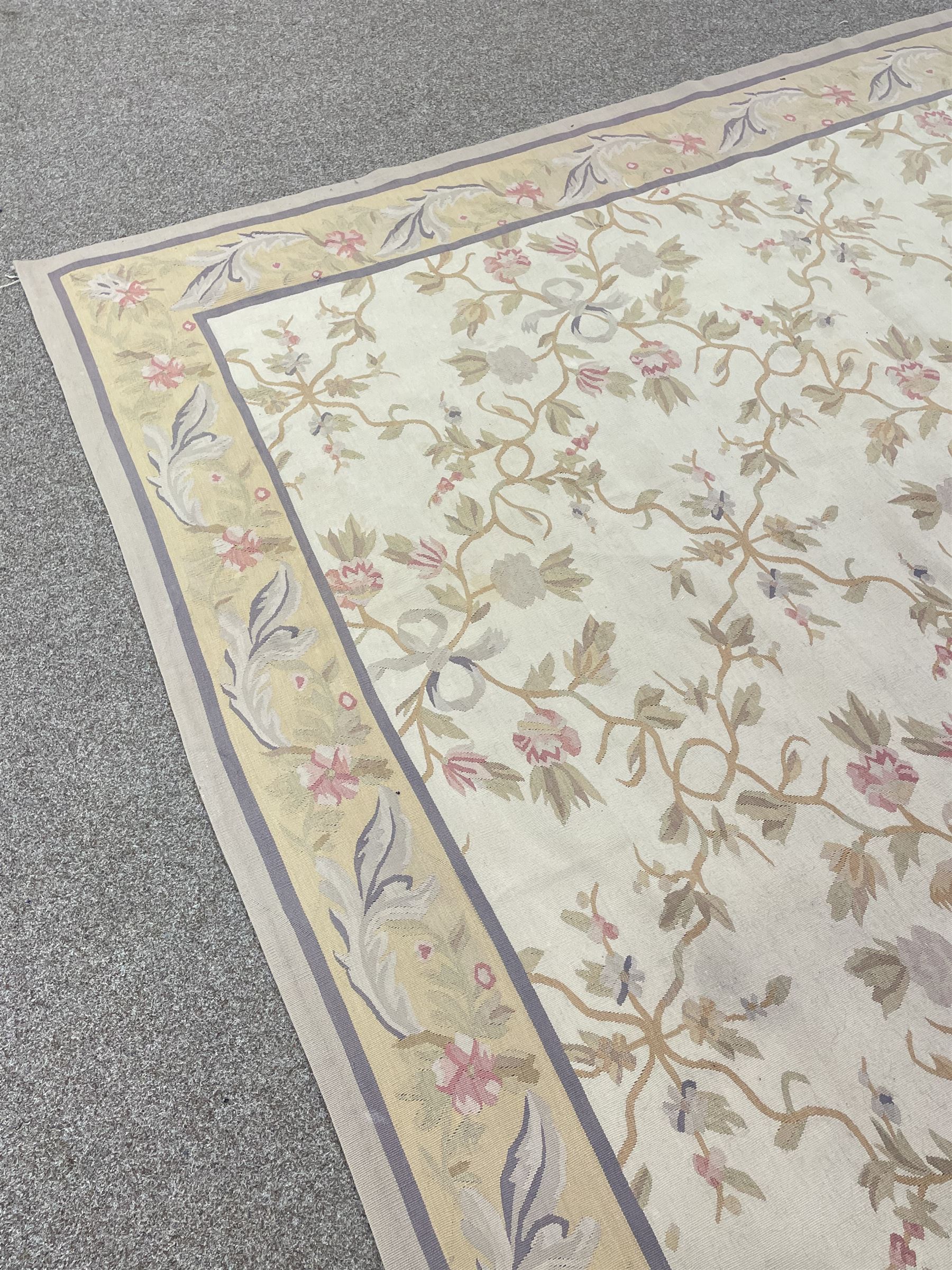 French style Aubusson rug, the pale ground field decorated with interlacing foliage and flower heads, repeating border 