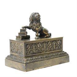 19th-century Grand Tour patinated bronze inkwell, surmounted by a recumbent lion, the beast modelled in the antique manner with one paw resting upon a stack of books, emblematic of strength, learning and guardianship. The stepped rectangular base cast with classical foliate friezes, fitted with multiple apertures and an inset ceramic inkwell and pounce pot; an erudite decorative object in the Grand Tour tradition, drawing on Renaissance and Roman prototypes, W12.5cm H11.5cm