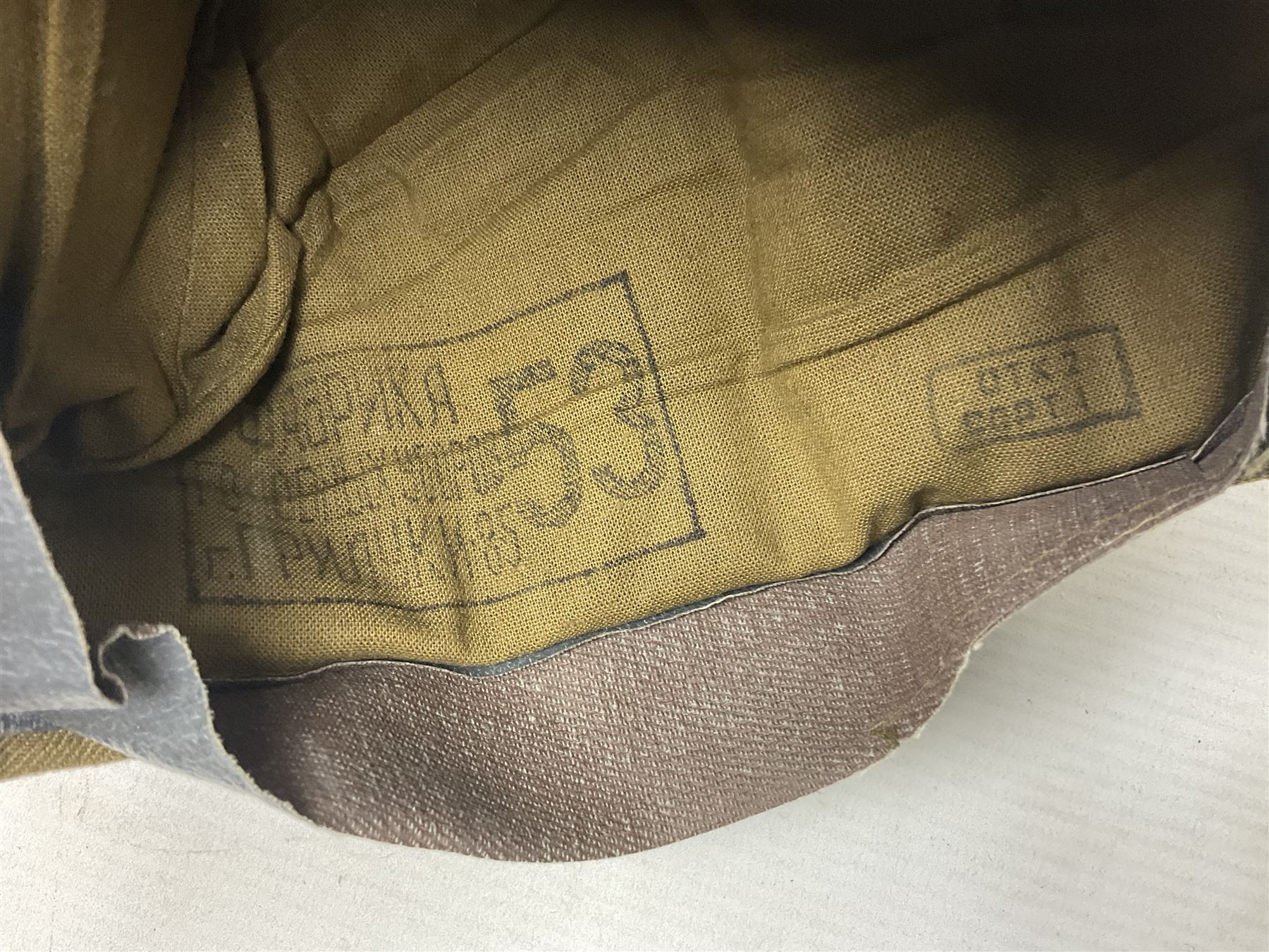 Four side caps - WW2 Russian, post-WW2 Russian and two East German; all with badges, one with multiple metal badges (4)