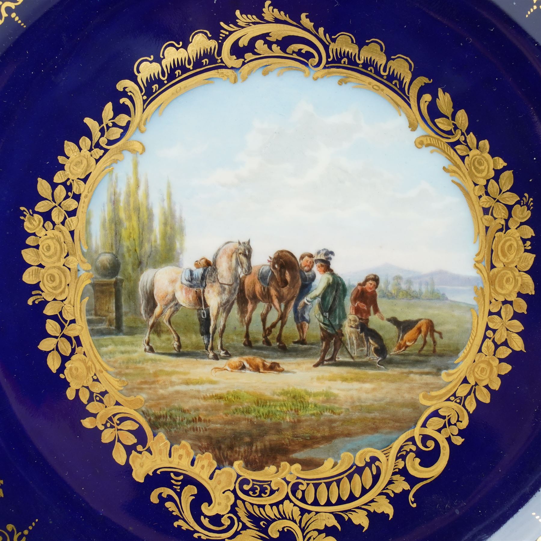 19th century Meissen cabinet plate, the reticulated border modelled with trellis panels and forget-me-nots,  the cobalt blue well with gilt bordered central reserve painted with a scene of a hunting party resting after Philips Wouwerman (Dutch 1619-1668), underglaze blue crossed swords and indistinct impressed numbers verso, D26cm