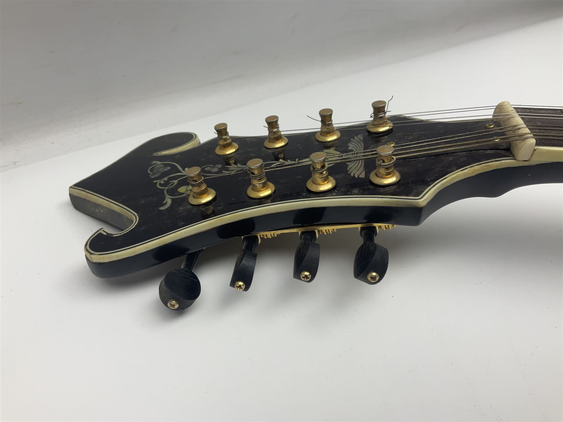 Eastern F-hole eight-string mandolin with black finish and mother-of-pearl inlay of a man riding a winged horse/unicorn amongst clouds and stars with playing card suits to the fingerboard L71cm