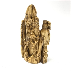 19th century Japanese carved mammoth ivory figure group, modelled as Fukurokuju and two attendants, carved verso with prunus, H17cm