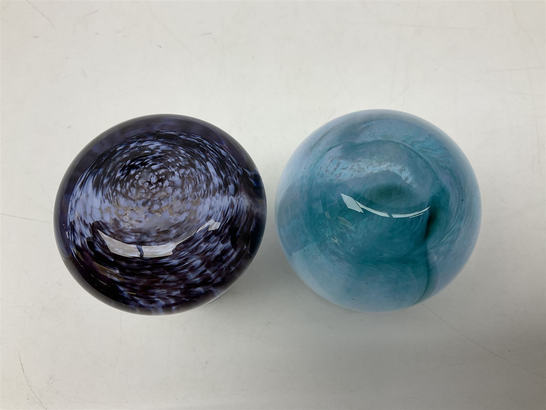Three millefiori paperweights, together with a green glass dump paperweight with air bubble inclusions, Caithness Daisy and Cauldron paperweights and two small Caithness glass vases, tallest H9cm
