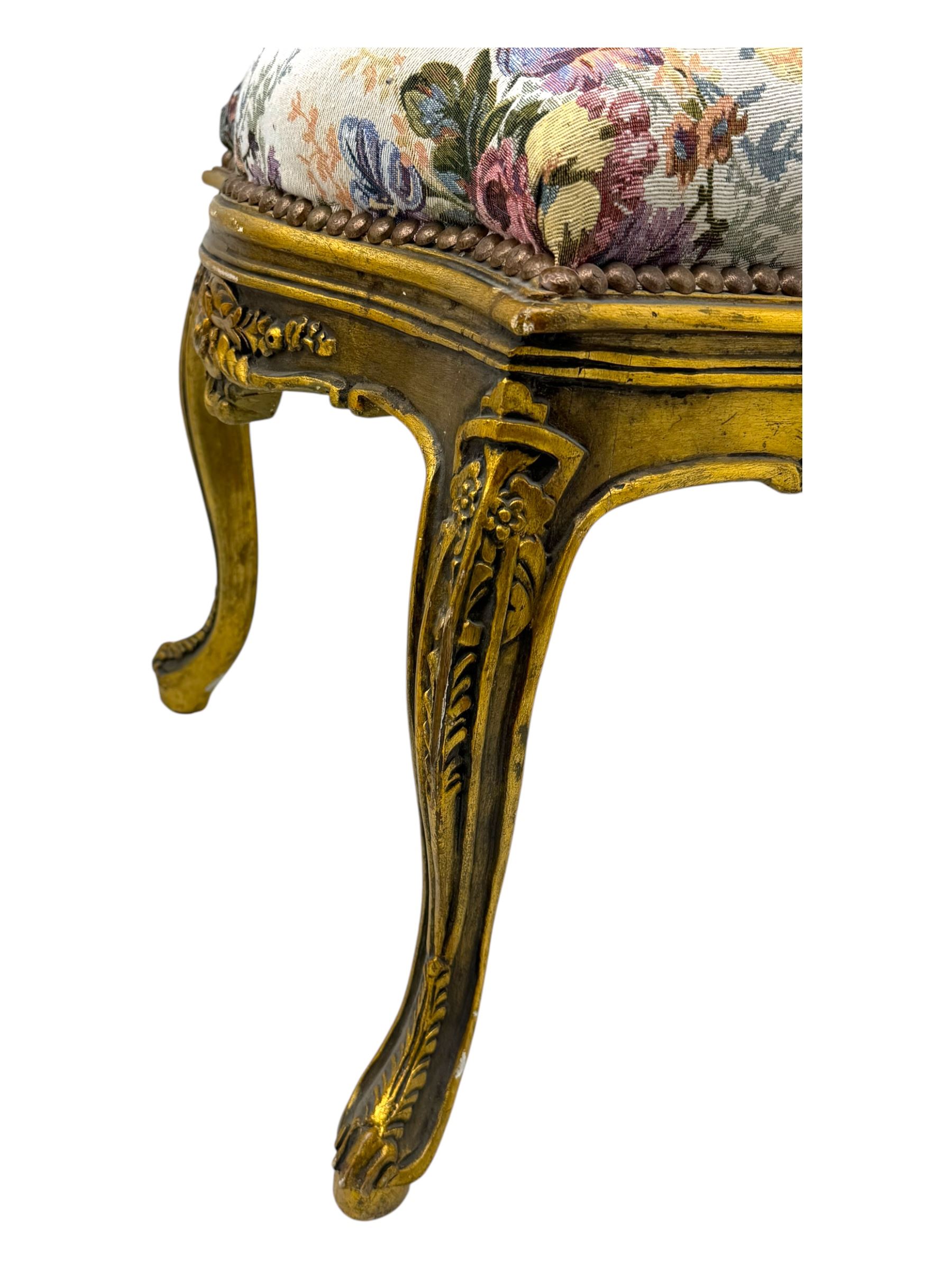 Pair of Louis XV-design giltwood stools, each upholstered in floral tapestry fabric, the carved frame adorned with scrolling foliage and shell motifs, raised on cabriole supports