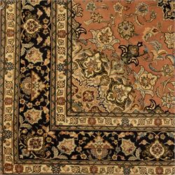 Persian Kashan style rug, salmon pink ground, central conforming lobed medallion in ivory and indigo, with palmette pendants, framed scrolling arabesques of lotus blossoms and palmettes, within navy border of meandering vines and flowerheads between ivory guard stripes 