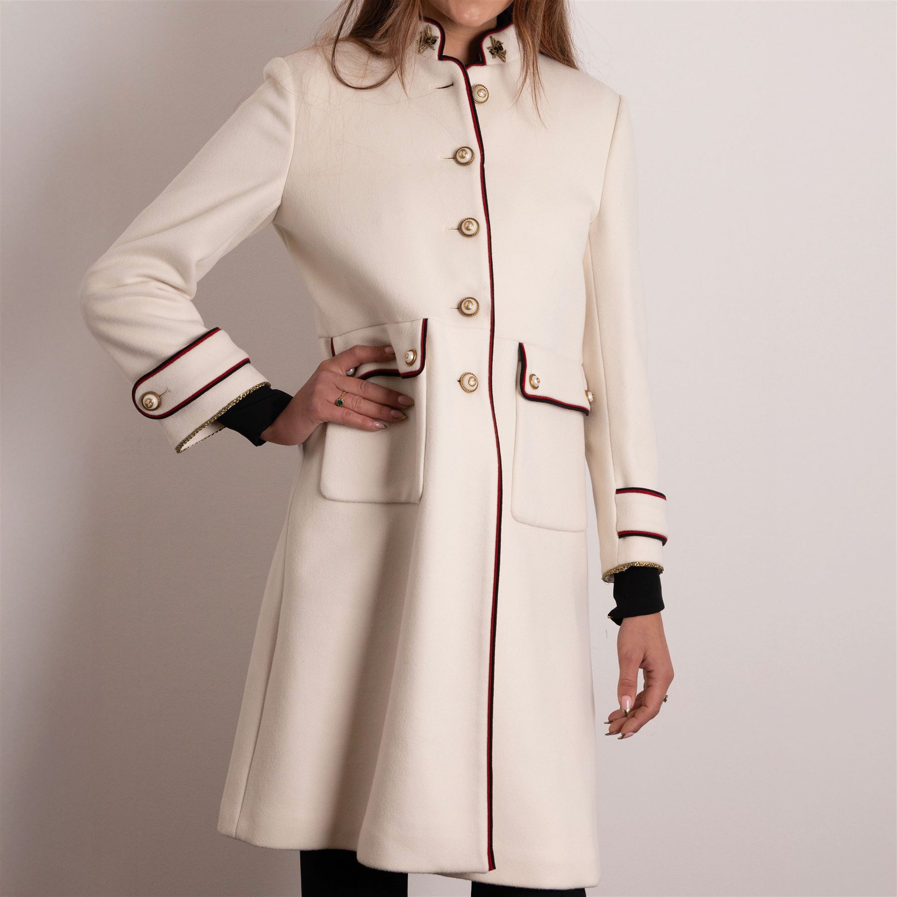 Gucci - bee embroidered wool single-breasted military coat, from the Autumn/Winter 2017 collection under Alessandro Michele, in ivory, with stand collar, red and navy trim, pearlescent and gold-tone button fastening and embroidered bee detailing to the collar, size 14, unused with original garment bag and tags