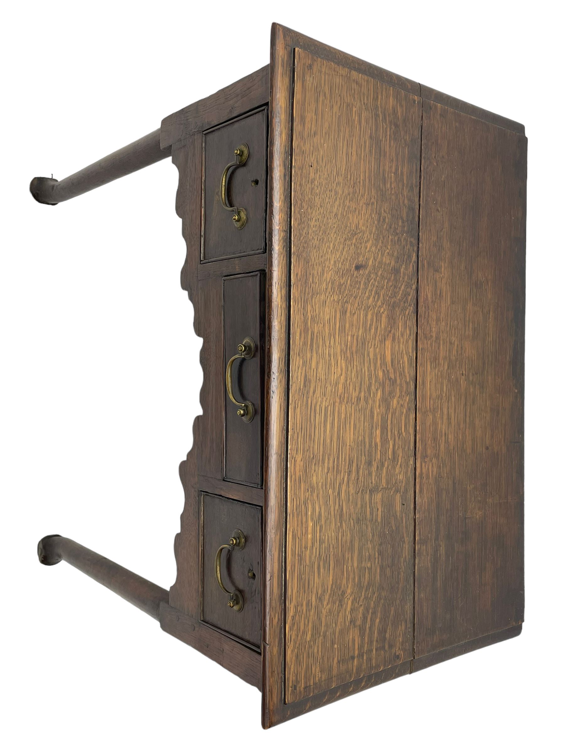18th century oak low-boy, ovolo-moulded rectangular top over three cock-beaded drawers, circular brass handle plates and D-shaped handles, shaped and stepped arched apron, on cabriole supports 