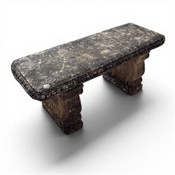 Weathered cast stone three-piece garden bench, with rectangular seat with egg-and-dart moulded edge, raised on end supports decorated with S-scrolls and fruiting vines