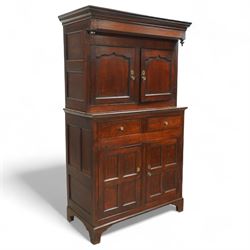 Early 19th century Welsh oak kitchen cupboard, the projecting cornice with twin cupboard doors, the rectangular base over two frieze drawers and panelled cupboard doors, raised on bracket feet, with fielded and arched panel variants to front and sides