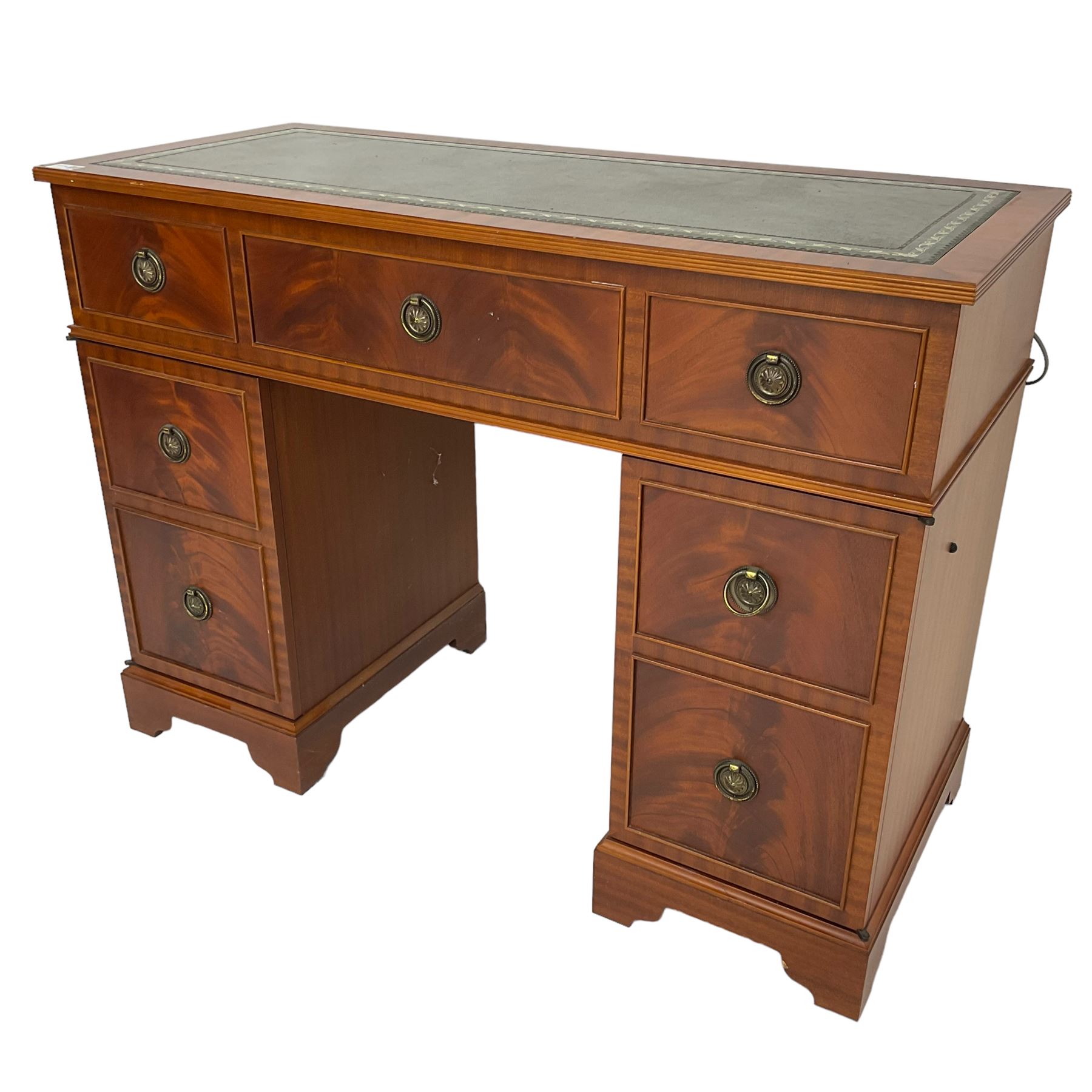 Music system in the form of a Georgian design twin pedestal desk, the reed moulded rectangular top hinges to reveal Garrard turntable with Dynatron Amplifier, fitted with speakers enclosed by two doors disguised as drawers, on bracket feet