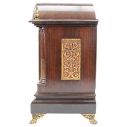 Winterhalder and Hoffmeier - German 8-day three train Edwardian oak cased mantle clock, with a break arch pediment, brass sound frets to the sides and conforming glazed door beneath, with flanking reeded pilasters on a stepped plinth raised on paw feet, sheet brass dial with fretted spandrels and matted dial centre, silvered chapter with Roman numerals, gothic steel hands and subsidiary dials for pendulum regulation and chime select, going barrel movement, chiming the quarters and striking the hours on nine coiled steel gongs. With pendulum and keys.