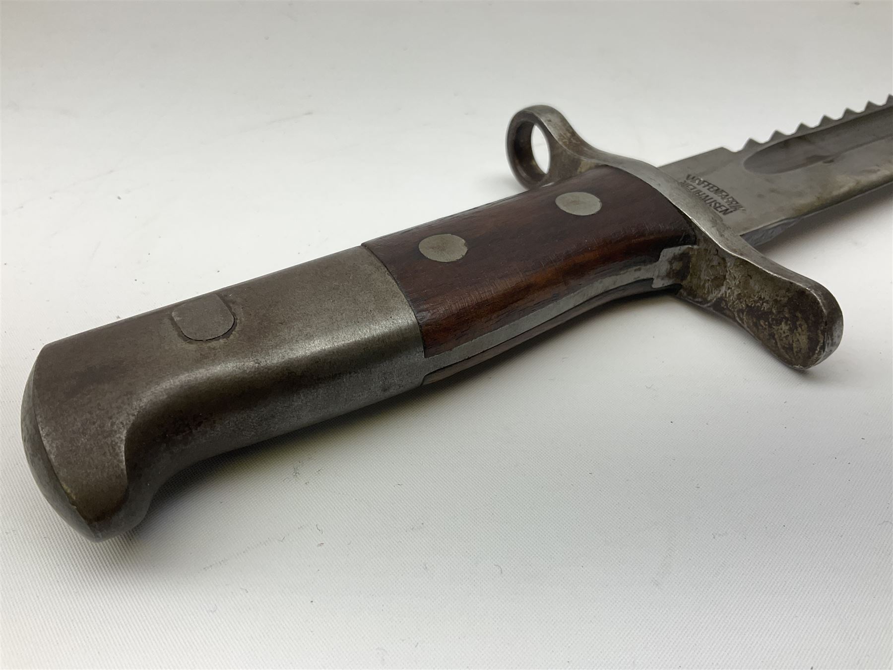 Swiss Schmidt-Rubin M1914 pioneer bayonet, with 48cm steel saw-back blade, the ricasso stamped, ''Waffenfabrik, Neuhausen'', the crosspiece stamped Swiss cross, steel scabbard, leather frog L64cm overall