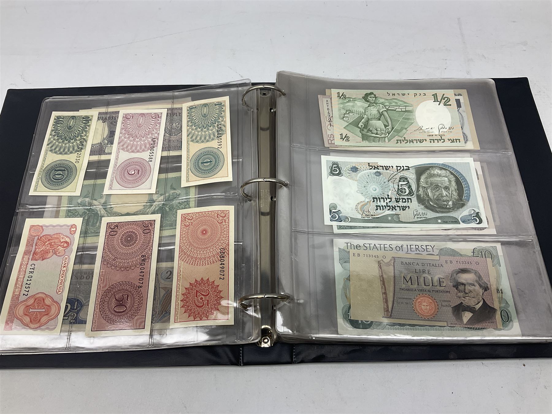 World banknotes, including Queen Elizabeth II The States of Jersey one pound 'DB202703', five pounds 'BB527762' and ten pounds 'AB651481', reserve bank of New Zealand two dollars '1L3 741894', King George V Straits Settlements one dollar 1st January 1935 'F/83 28924', various Bank of England notes etc, housed in two ring binder albums