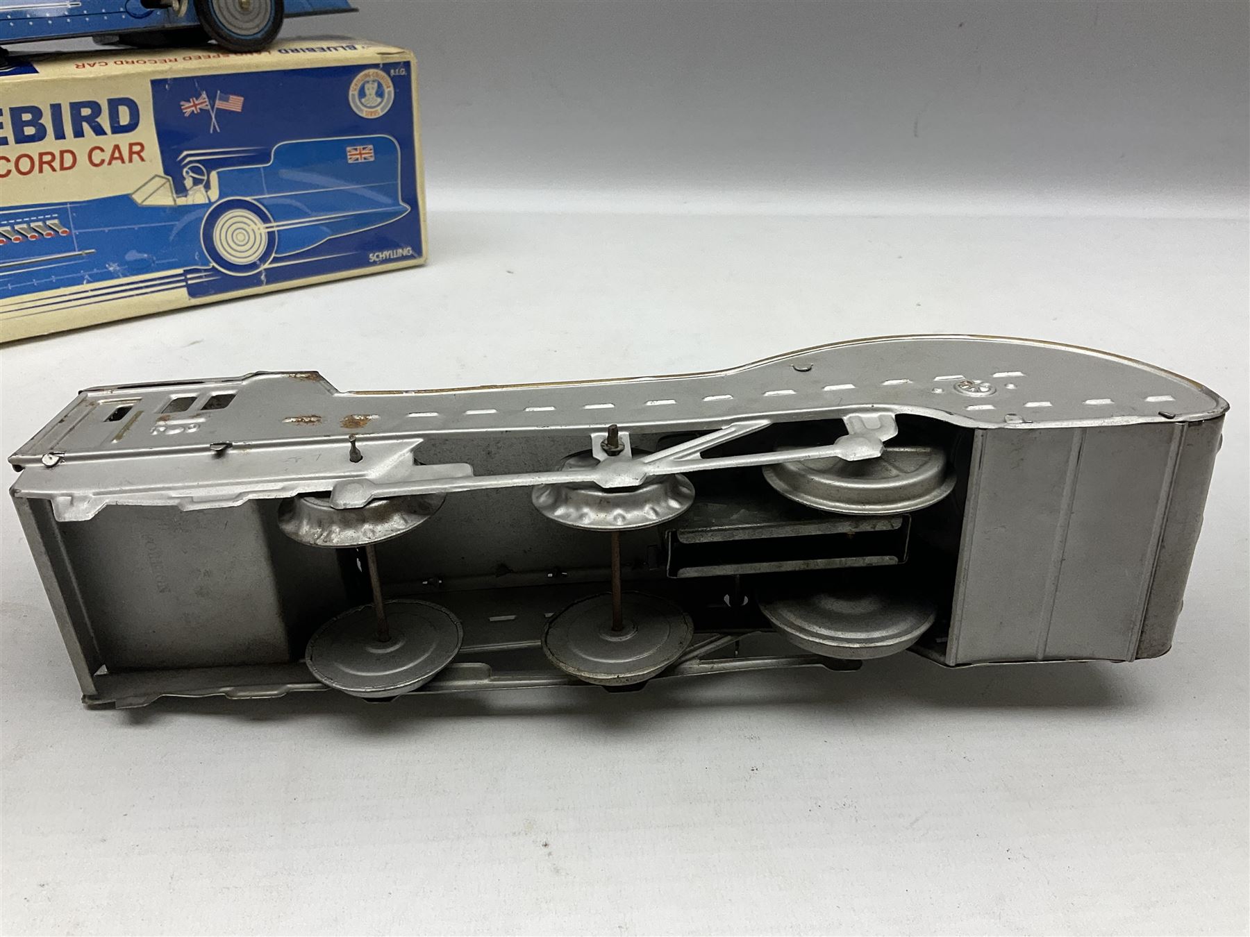 Schylling Collector Series clockwork tin-plate Sir Ian's Bluebird Land Speed Record Car with key and paperwork No.006080; boxed; and clockwork silvered tin-plate model of an 0-6-0 locomotive; unboxed (2)