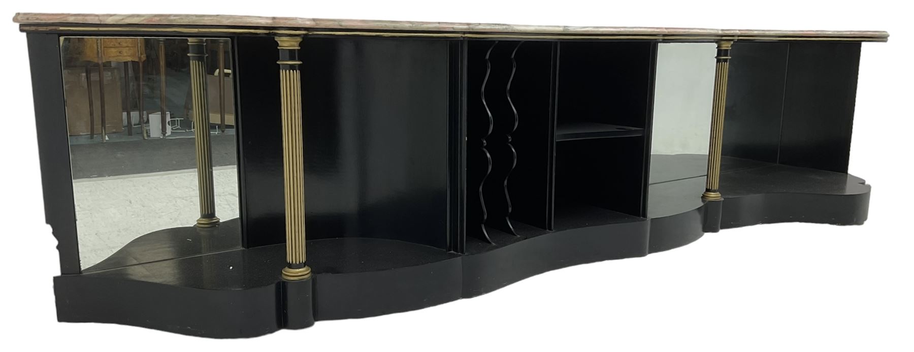 Italian ebonised and gilt serpentine corner console bookcase cabinet, shaped pink marble top over assorted shelves and dividers with fluted pilasters and mirror backs, on skirted base 
