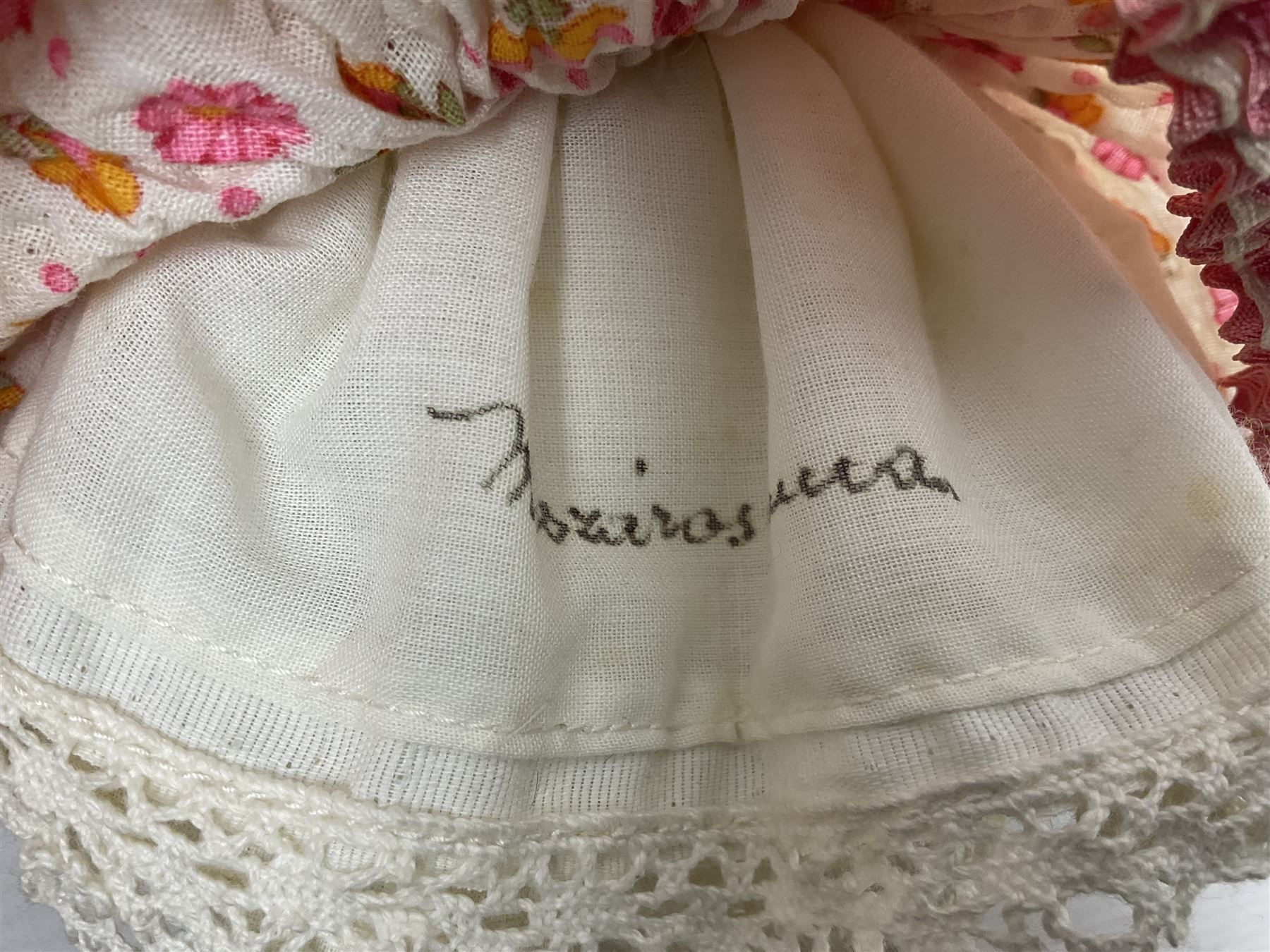 Anna Meszaros Hungary - three hand made needlewrok figurines - each wearing a lon floral dress and bonnet and holding a bouquet of flowers, tallest H32cm (3)  Auctioneer's Note: Anna Meszaros came to England from her native Hungary in 1959 to marry an English businessman she met while demonstrating her art at the 1958 Brussels Exhibition. Shortly before she left for England she was awarded the title of Folk Artist Master by the Hungarian Government. Anna was a gifted painter of mainly portraits and sculptress before starting to make her figurines which are completely hand made and unique, each with a character and expression of its own. The hands, feet and face are sculptured by layering the material and pulling the features into place with needle and thread. She died in Hull in 1998.