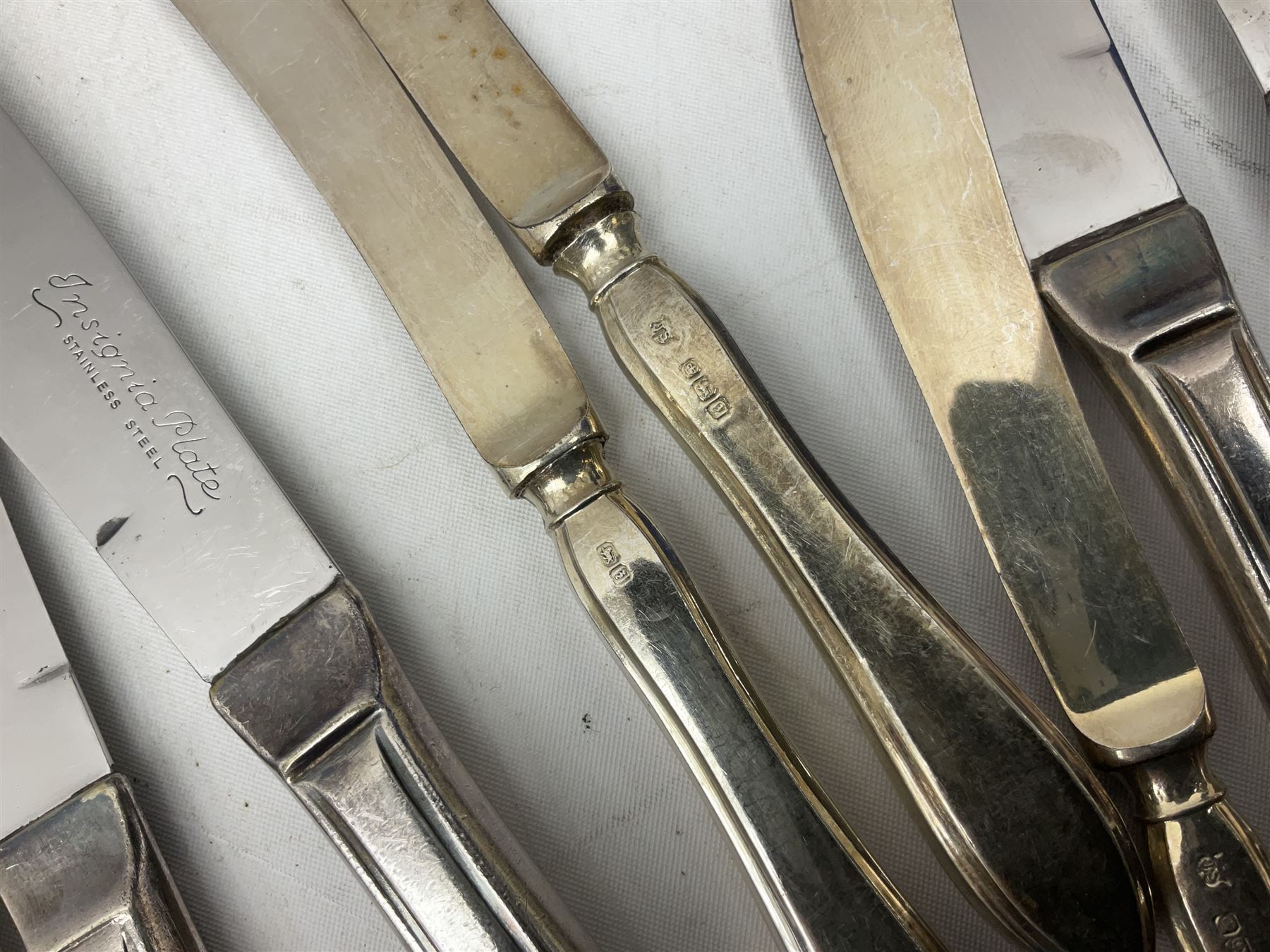 Four butter knives with hallmarked silver handles together with a Quantity of silver-plated cutlery stamped Ashberry and other stainless steel cutlery