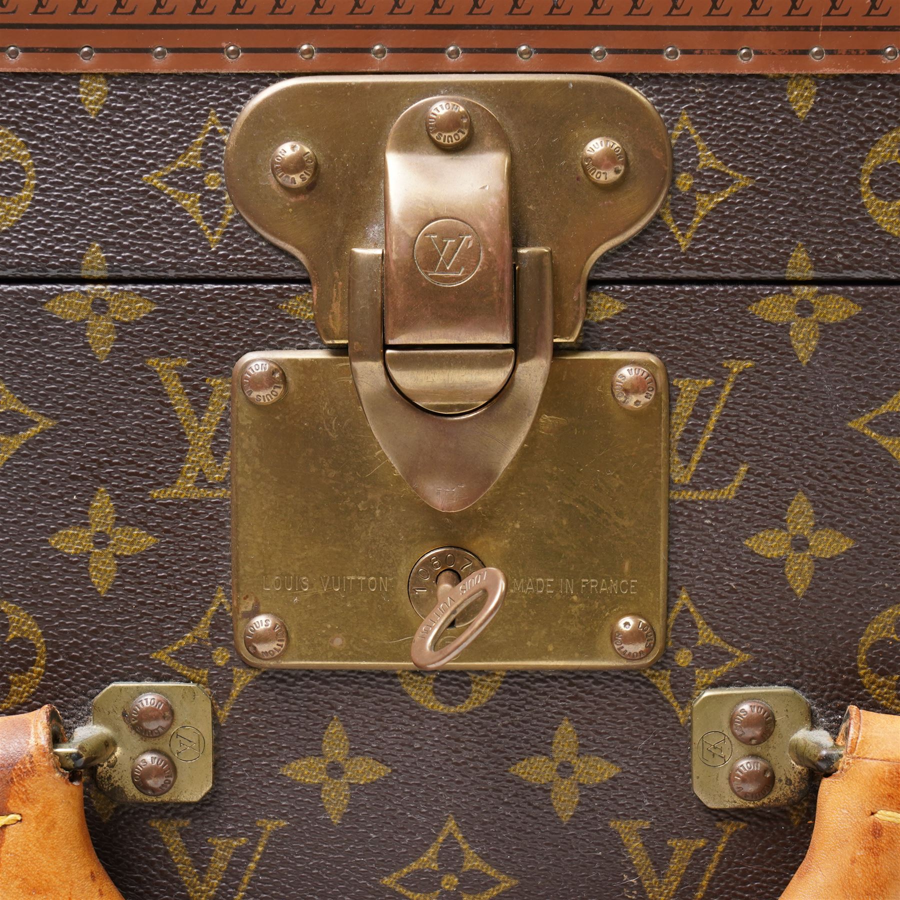 Mid-20th century Louis Vuitton monogram cabin trunk,  monogram canvas with lozine trim and brass mounts, single front leather handle with lock stamped Louis Vuitton with key code 1080701, the interior fitted with original webbing straps and lift-out tray, label to lid printed 'Avenue Marceau 78bis - Paris Nice - 2 Avenue de Suède' serial number 953998, circa1960s, with original key present
