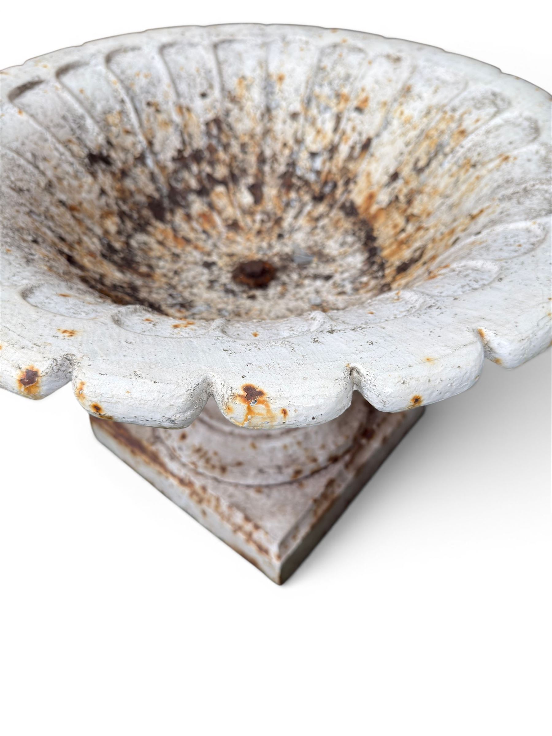 Coalbrookdale - pair of 19th century cast iron petal rim urns, squat form on square plinth, finished in distressed white paint, design registration number 133334, first registered 19 september 1860, number 19 in the Coalbrookdale Castings Catalogue (see illustration)