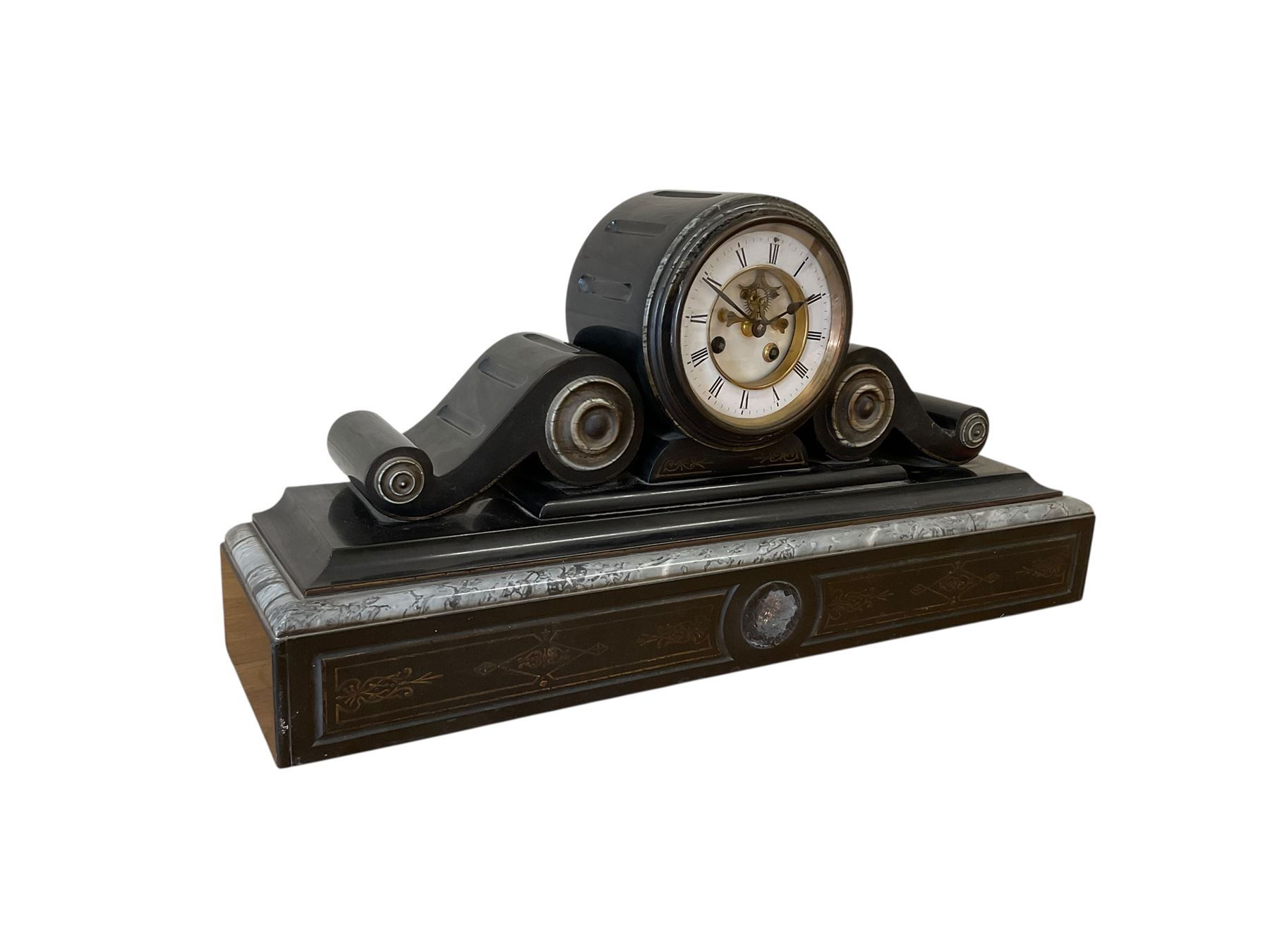 French- late 19th century 8-day Belgium slate and marble mantle clock, drum movement with volutes and conforming scroll side pieces, on a stepped plinth with incised decoration to the front, two-piece enamel dial with a visible Brocot deadbeat escapement, spade hands and Roman numerals, twin train, countwheel striking movement, sounding the hours and half-hours on a bell. With pendulum and key. 
