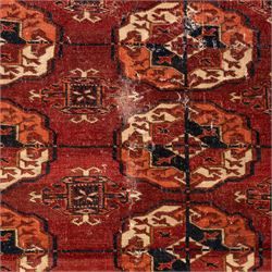 Persian Bokhara crimson ground rug, the field decorated with five rows of repeating Gul motifs with interspersed geometric design, enclosed by a guard band of further geometric-style Gul designs comprised of hook motifs