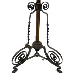Late 19th to early 20th century wrought metal and copper telescopic oil standard lamp, the lamp and reservoir on scrolled supports with waved band, handle operating telescopic action, tripod base with scrolled terminals and twisted decoration, splayed pad feet 