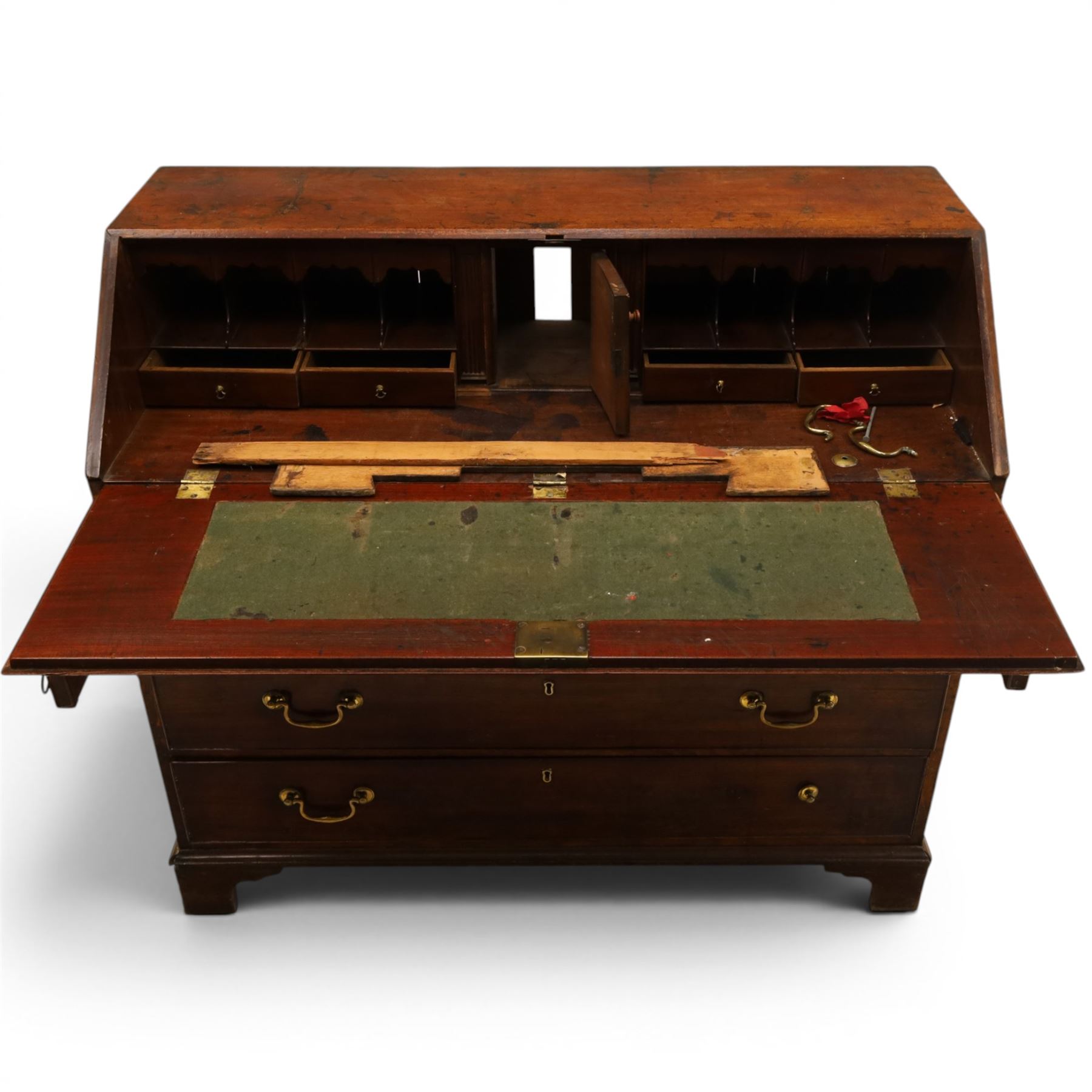 George III mahogany bureau of large proportions, the fall-front enclosing fitted interior with fluted column secret compartments and assorted pigeonholes and correspondence drawers flanking central cupboard, over four graduating cock-beaded drawers with original brass swan-neck handles, raised on bracket feet