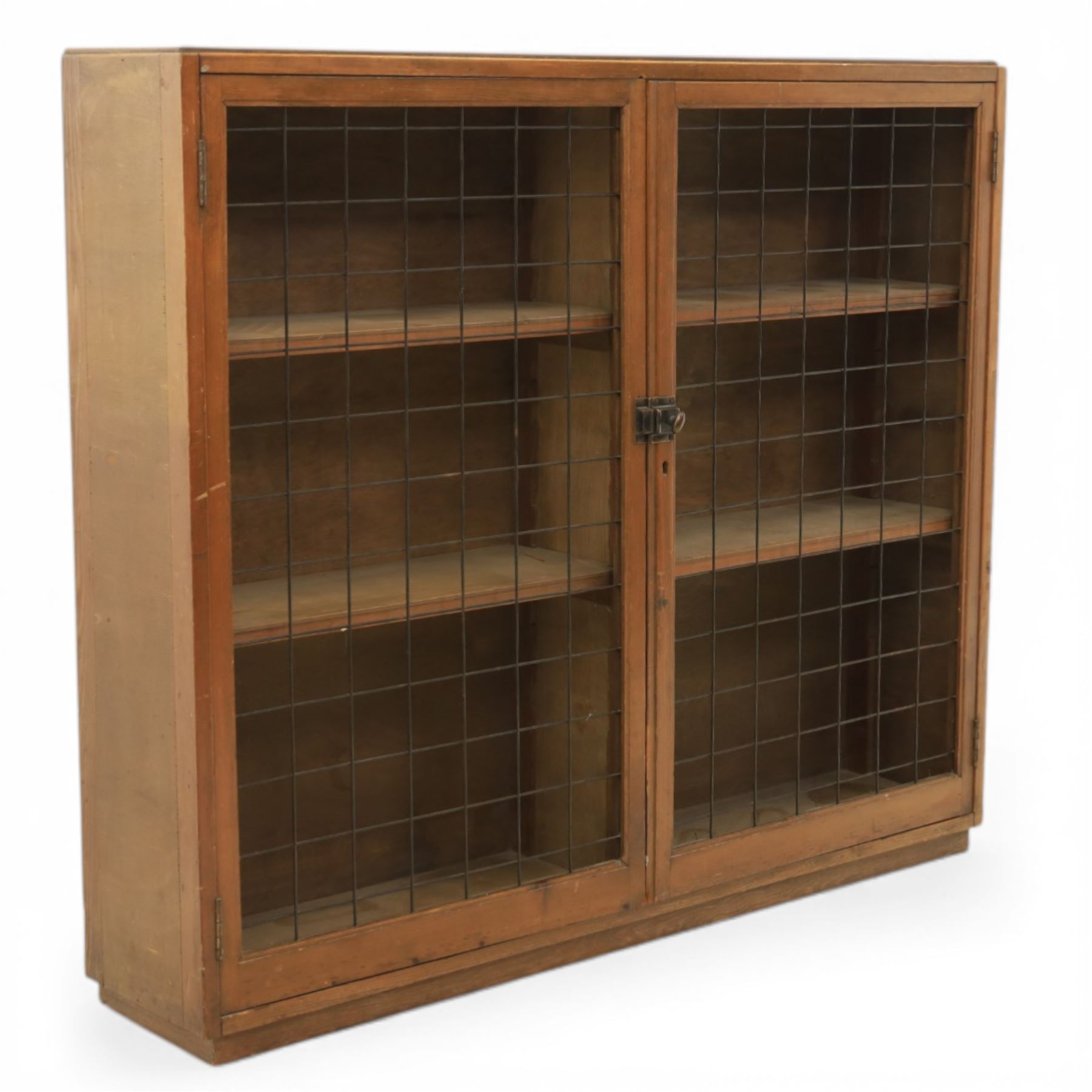 Rustic pine cupboard fitted with wire panelled doors, enclosing staggered adjustable shelving