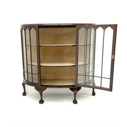 Early 20th century mahogany demi-lune display cabinet, single glazed door enclosing two lined shelves, ball and claw feet
