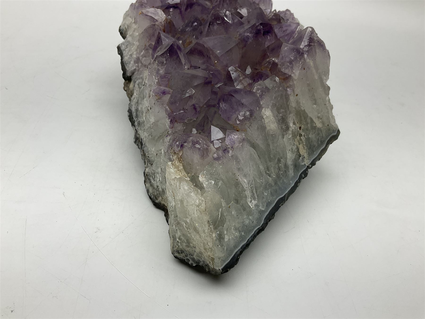 Amethyst crystal geode cluster, with well-defined crystals of various sizes, H10cm, L30cm