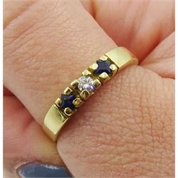 Gold three stone round brilliant cut diamond and princess cut sapphire ring, stamped 18kt